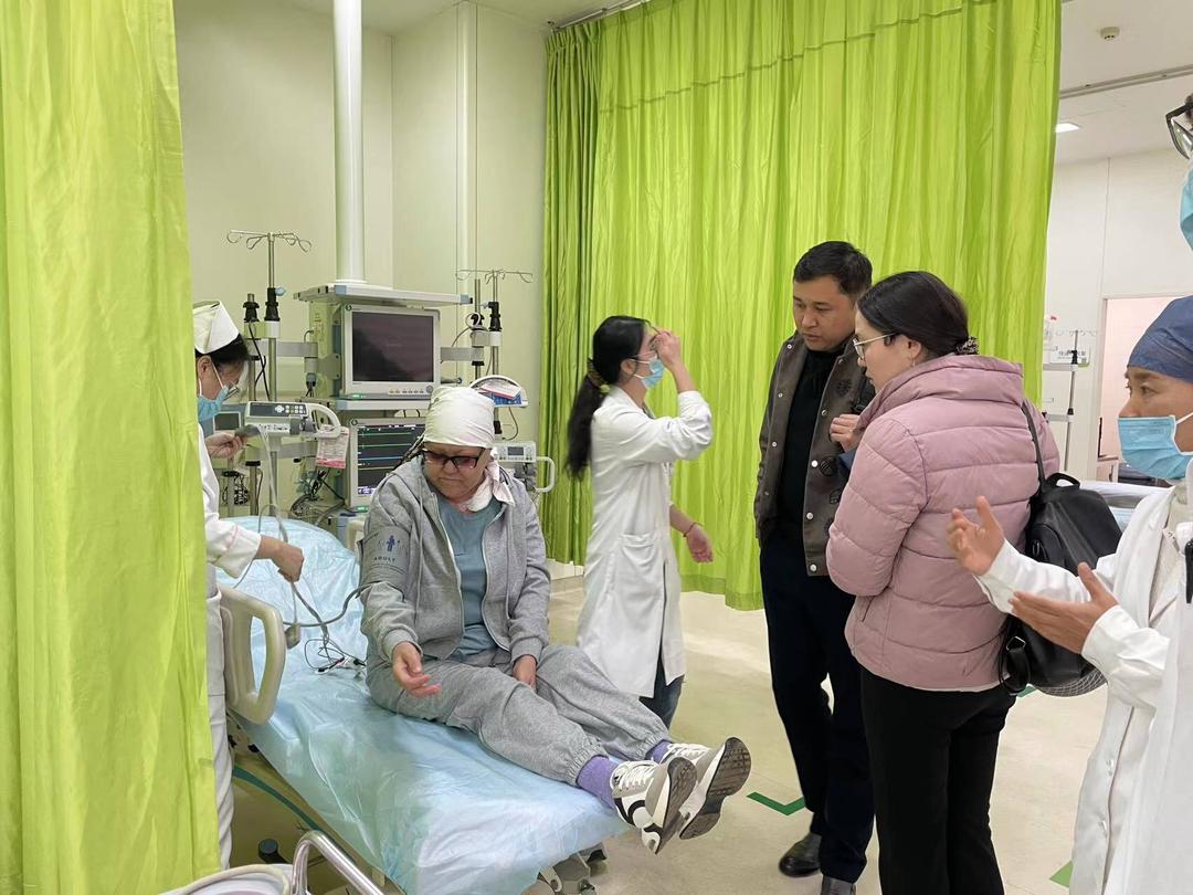 Patient speaking with hospital staff in a treatment area